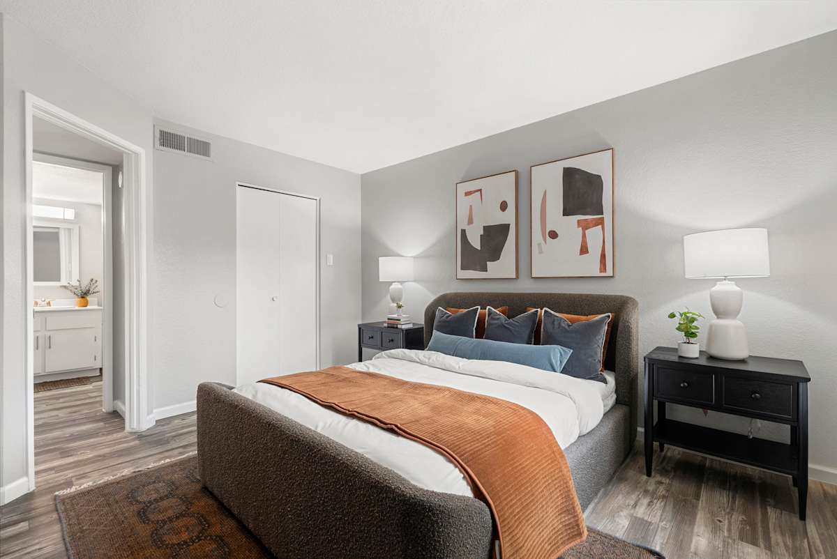 Furnished bedroom and bathroom entry at West 35th Apartments.