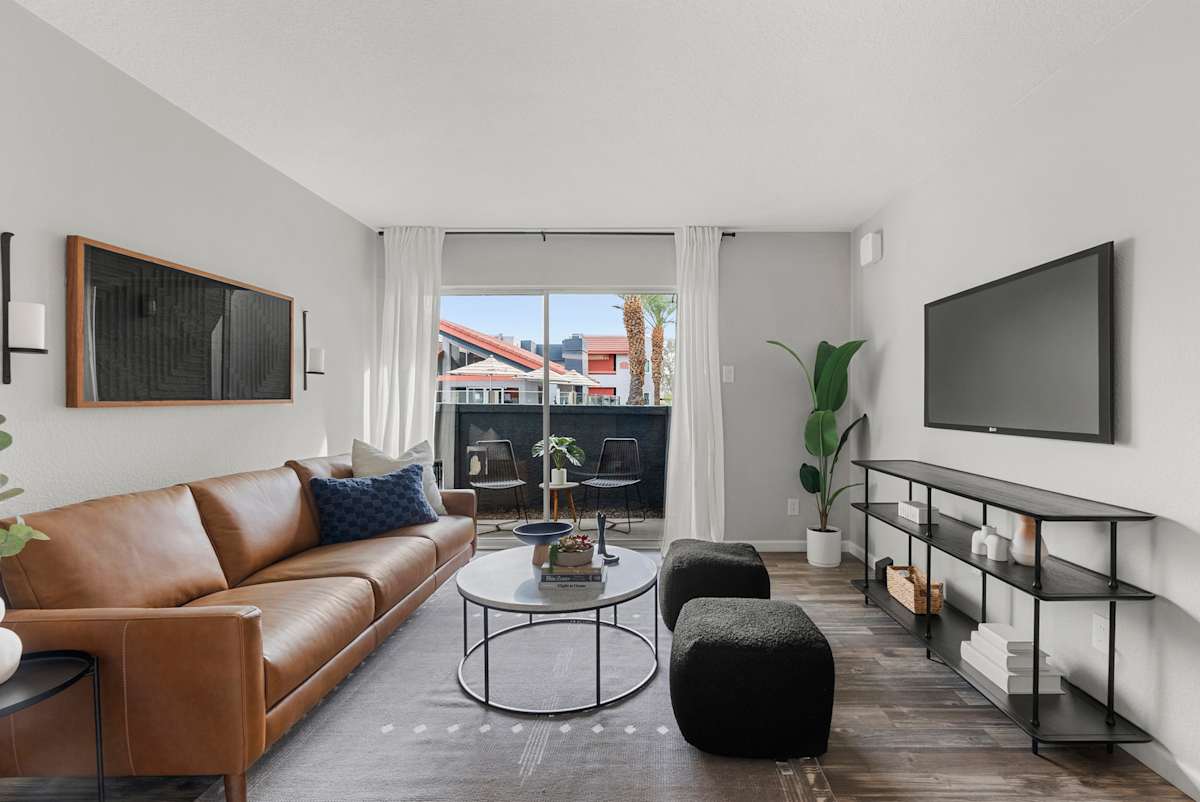 Furnished living room and balcony at West 35th Apartments.