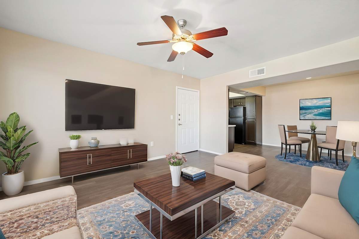 Furnished apartment living area shown — representative home at Sonoran Apartment Homes.