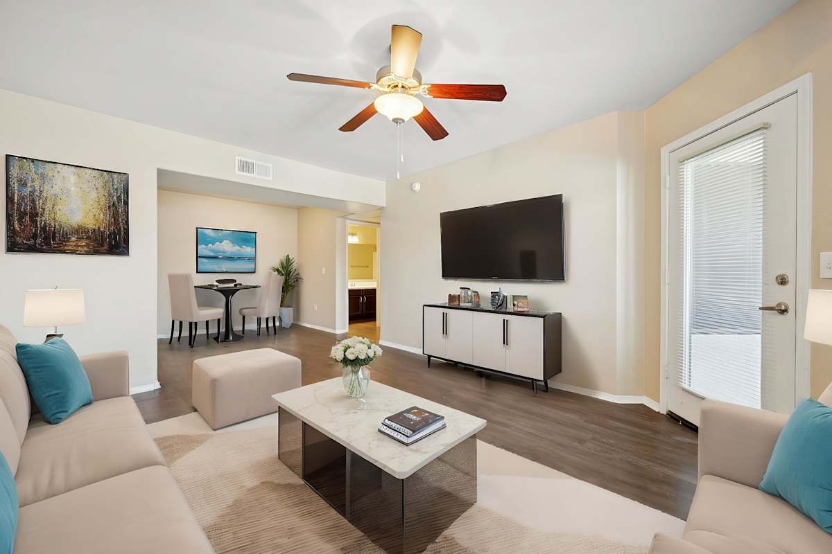Furnished apartment living area shown — representative home at Sonoran Apartment Homes.
