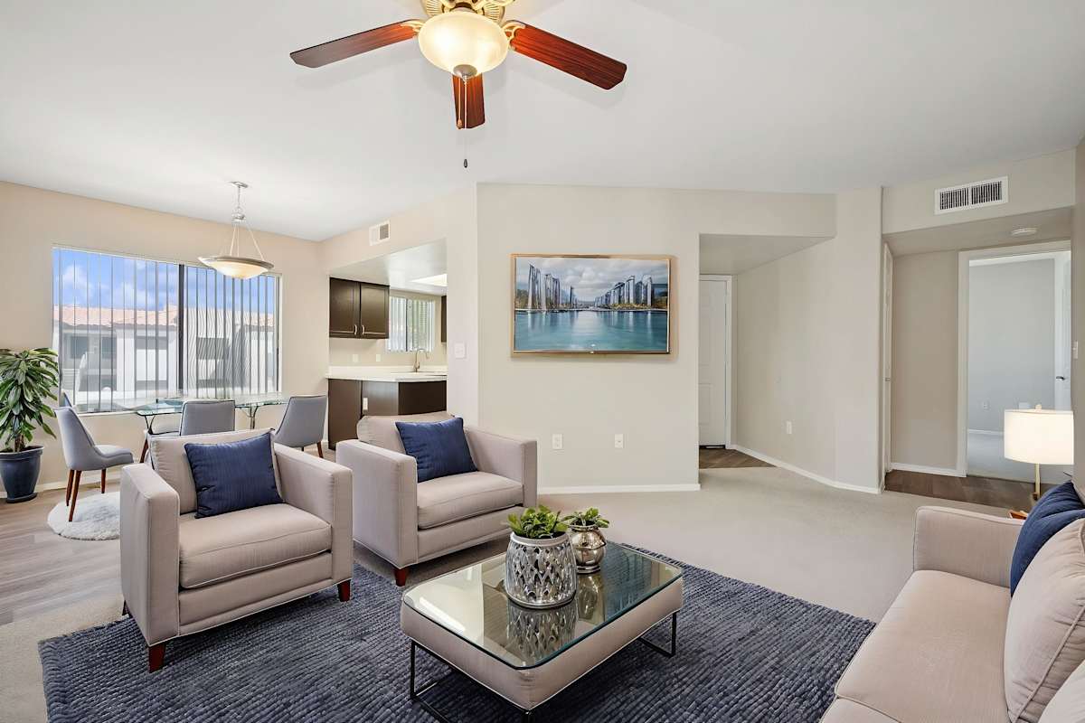 Furnished apartment living area shown — representative home at Sonoran Apartment Homes.