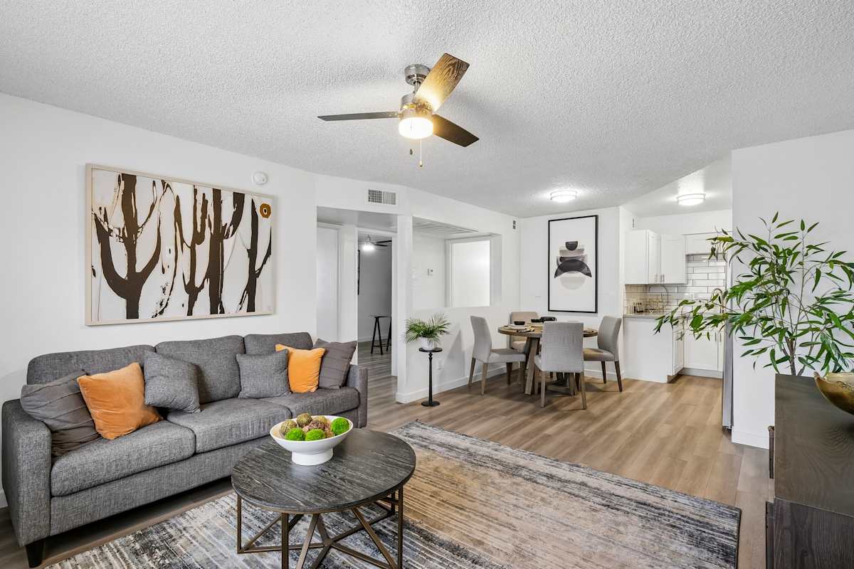 Furnished apartment living area shown — representative home at Ember at North Phoenix.