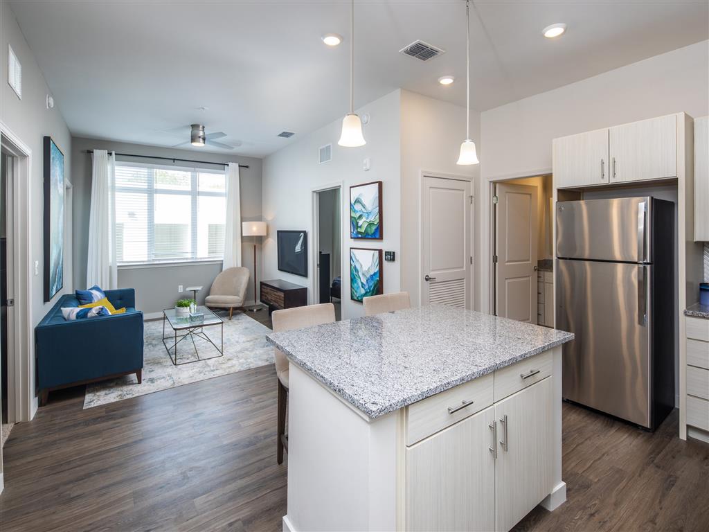 Open kitchen and living room with stainless steel appliances at 10X Tarpon Springs