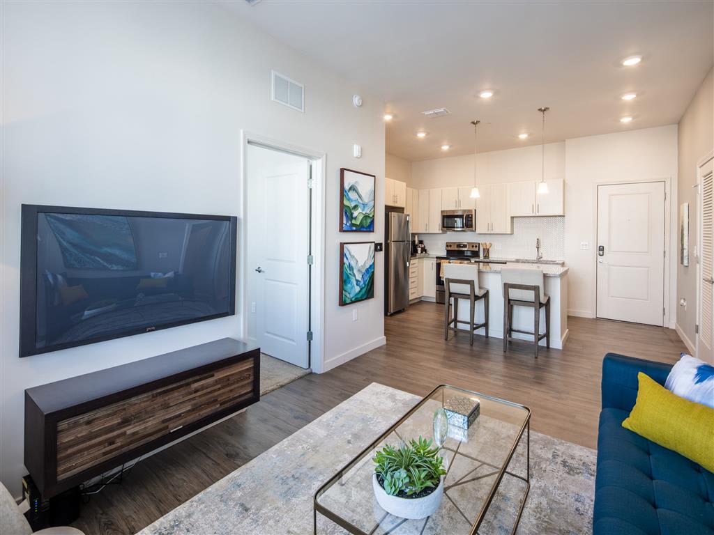 Living room with television and open kitchen at 10X Tarpon Springs