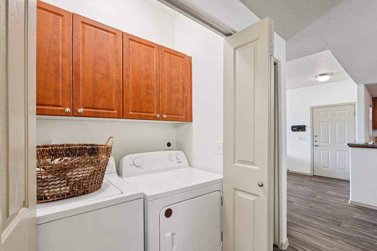 In-home laundry area — representative home at Del Mar Apartments.