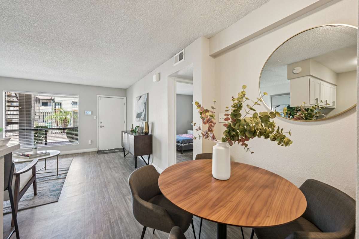 Furnished dining area with a round table — view 1 at Ardella on 67th.