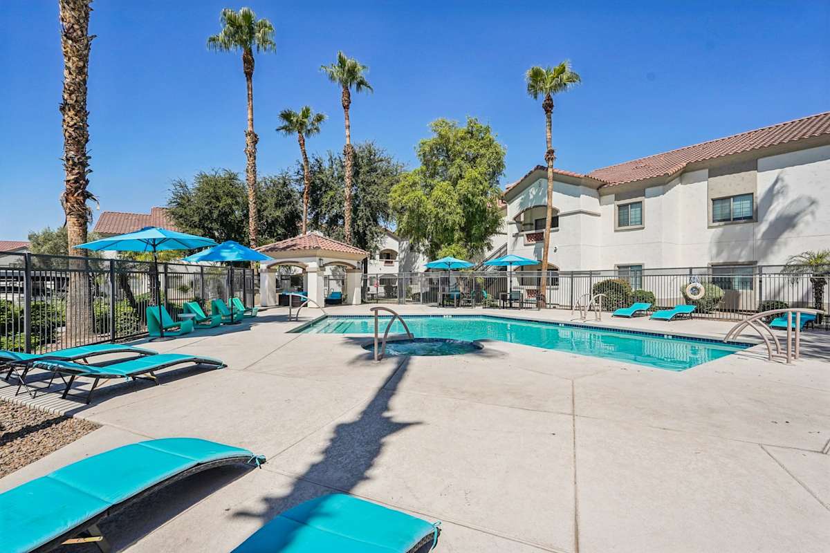 Pool and poolside area at Del Mar Apartments.