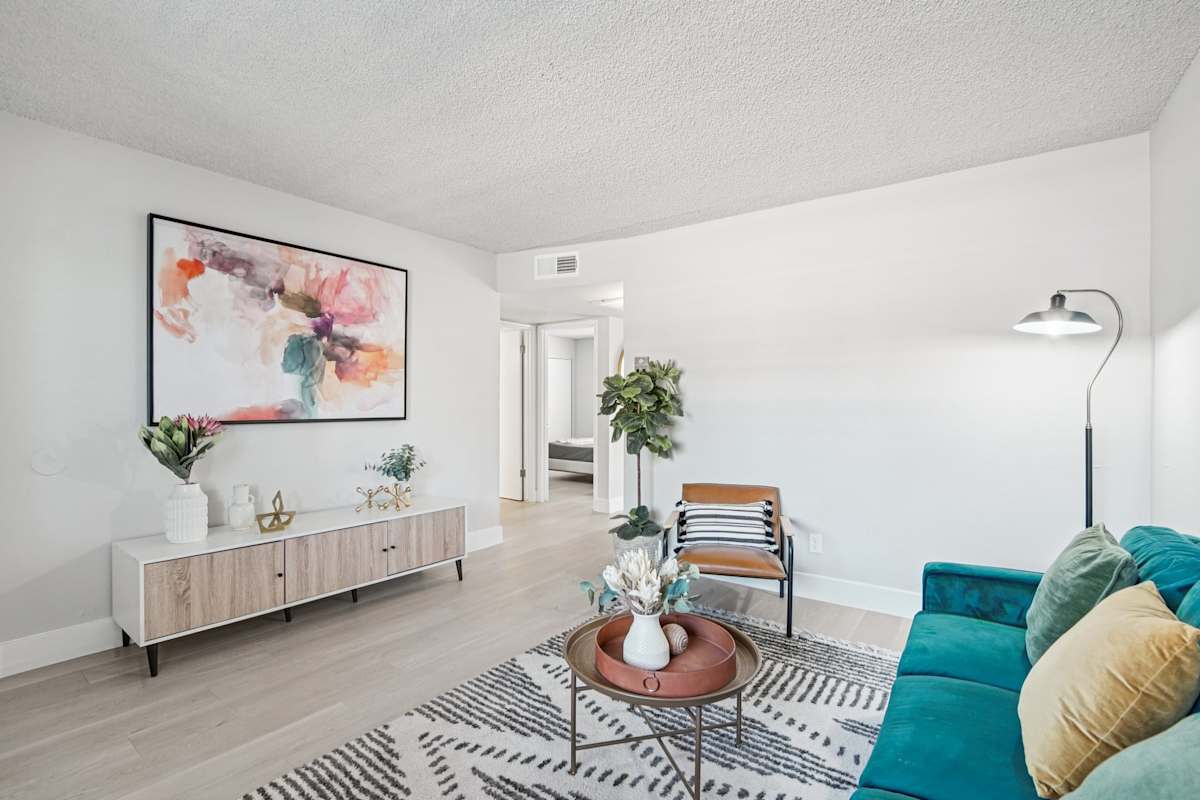 Furnished apartment living area shown — representative home at Ardella on 28th.