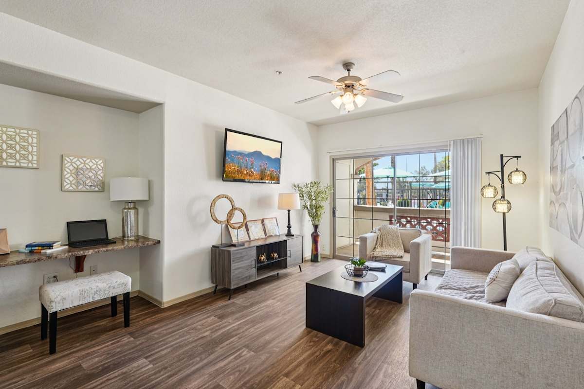 Furnished apartment living area shown — representative home at Del Mar Apartments.