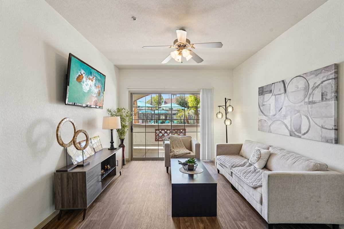 Furnished apartment living area shown — representative home at Del Mar Apartments.