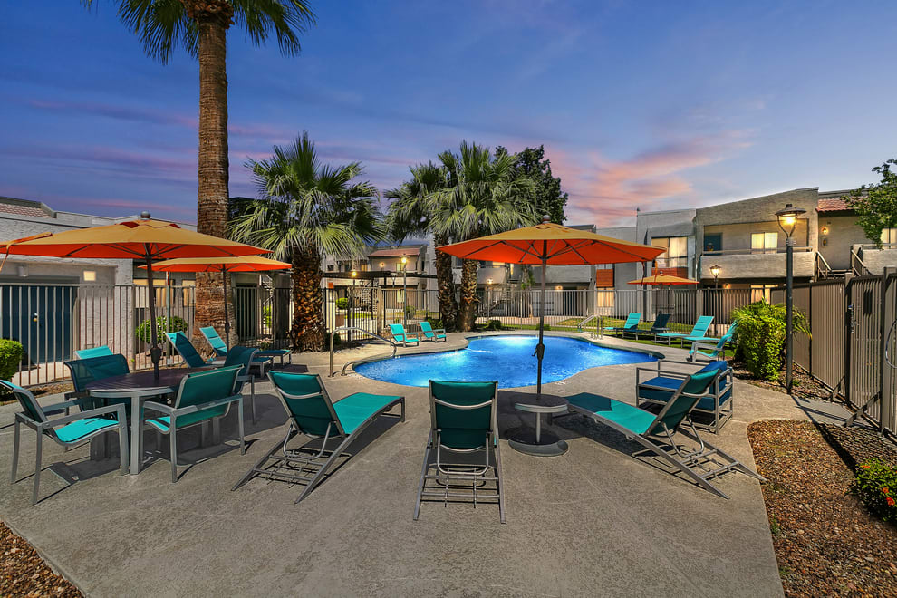 Poolside seating beneath orange umbrellas — view 1 at Ardella on 67th.