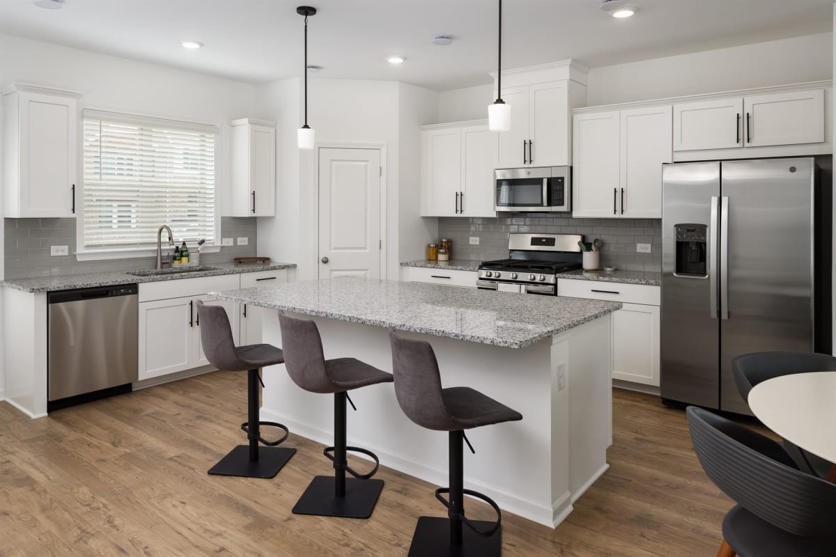 Waverly Village kitchen with island and stainless appliances - Lawrenceville, GA
