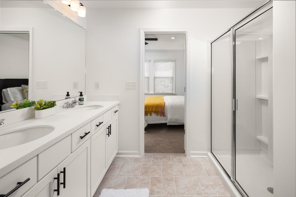 Waverly Village primary bathroom with double vanity and walk-in shower - Lawrenceville, GA
