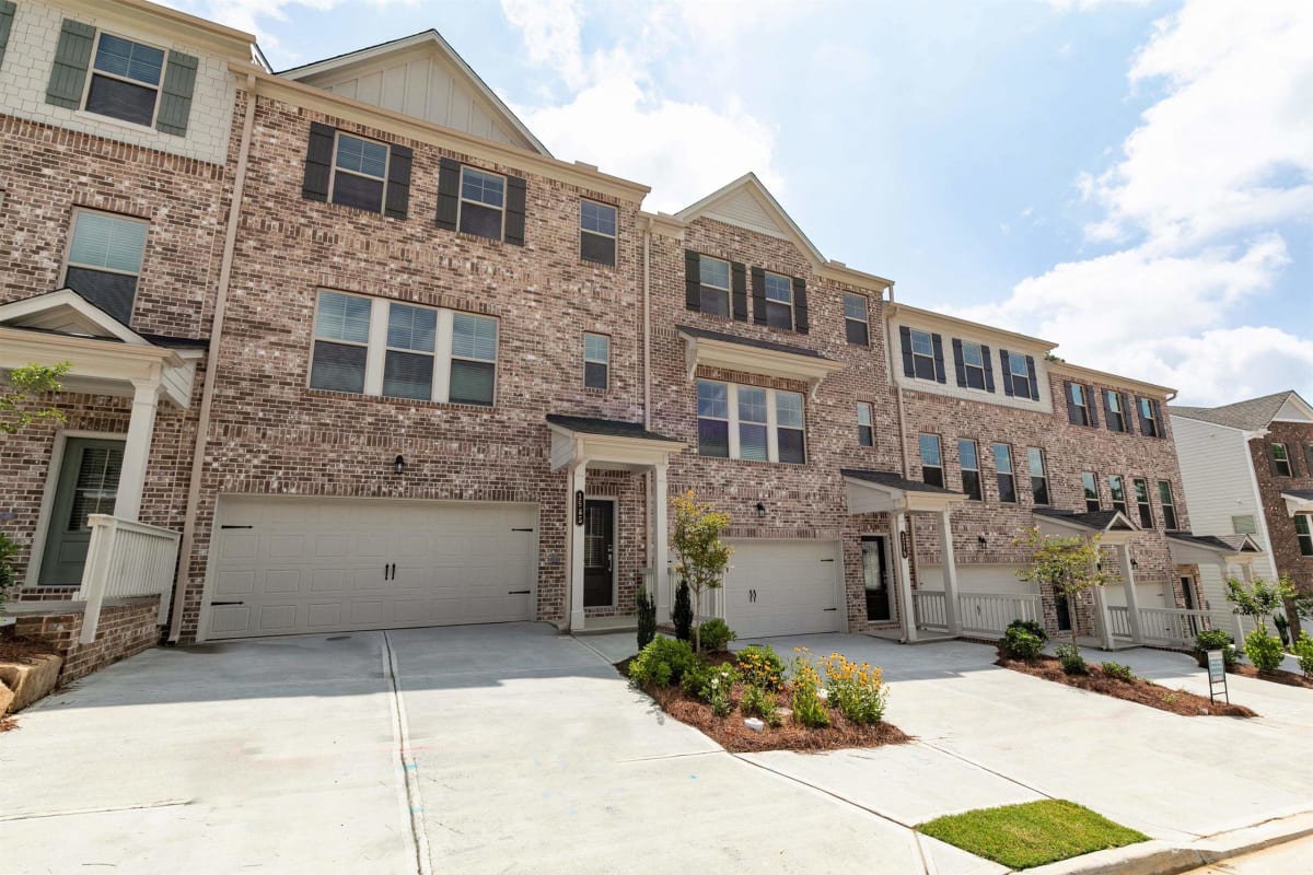 Waverly Village Kingston townhome exterior with driveway and garage - Lawrenceville, GA