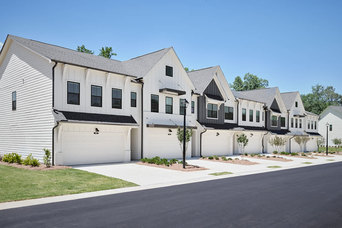 The Bend at Pettit Creek townhome exteriors with garages - Cartersville, GA