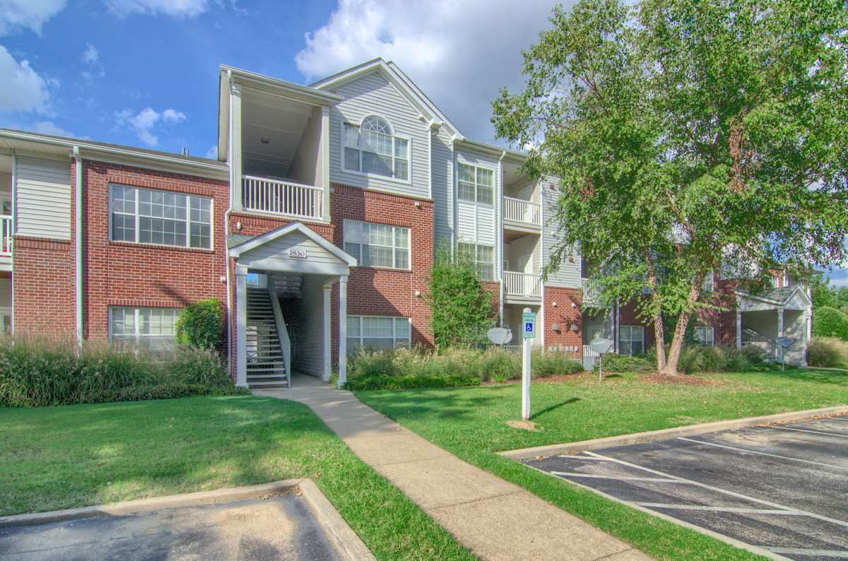 Enclave at Wolfchase apartment building exterior with trees - Memphis, TN