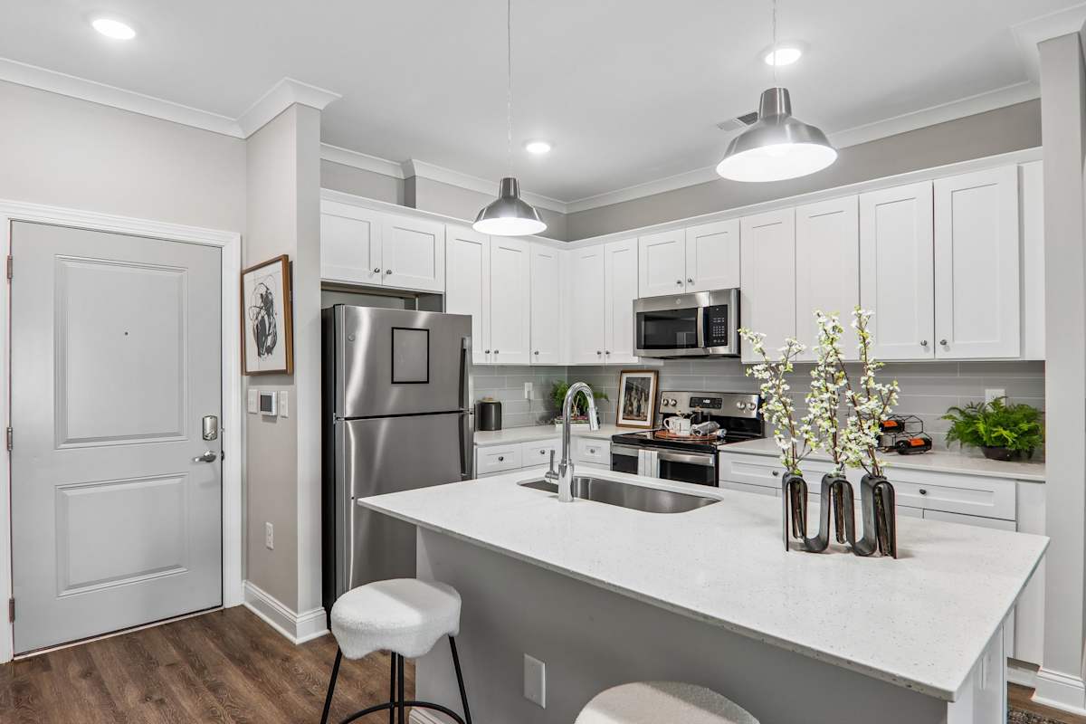 The One at Spartanburg model kitchen with white cabinets and island - Spartanburg, SC