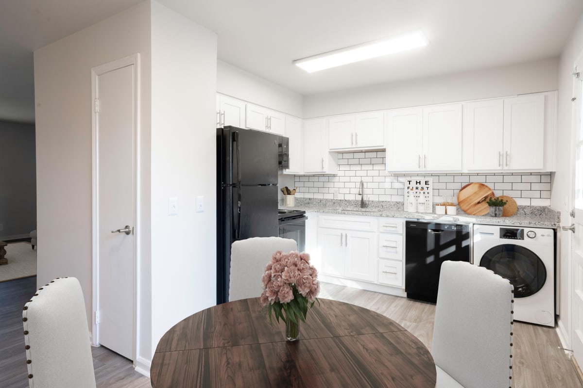 Venue at Carrollton kitchen and dining area with white cabinets - Carrollton, GA