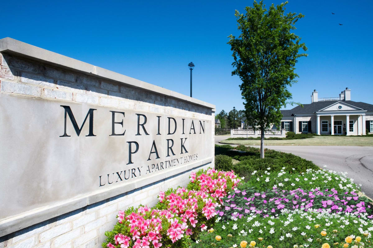 Meridian Park Apartments community entrance signage with flower beds - Collierville, TN