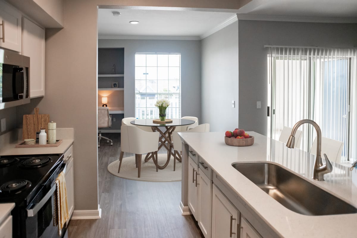 The Moorings kitchen and dining area with built-in desk nook - League City, TX