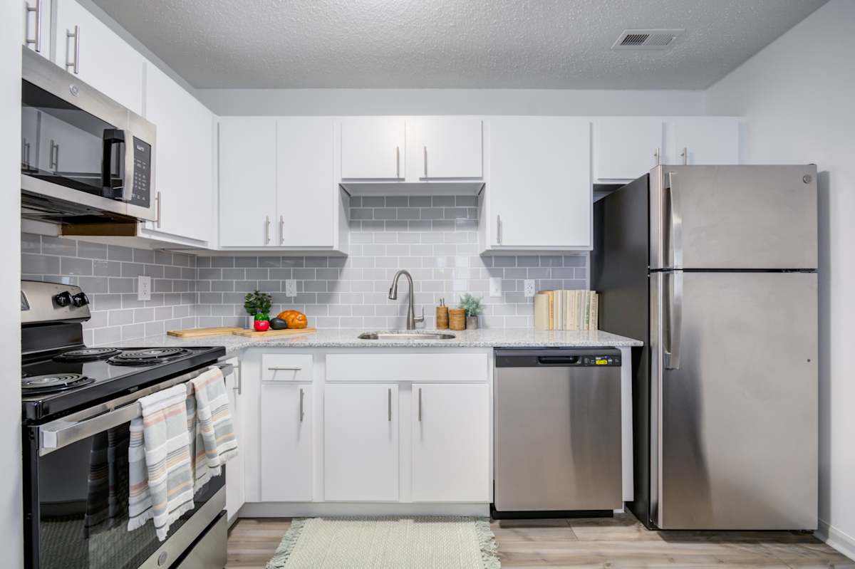 The Waters at Chenal Apartments kitchen cabinetry and refrigerator - Little Rock, AR