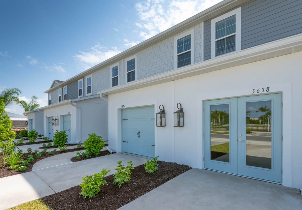 Martinique at Lakewood Ranch townhome exterior with garages - Lakewood Ranch, FL
