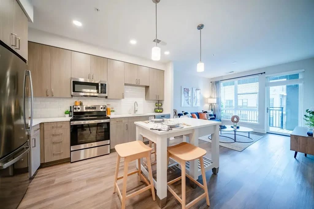 The Rae apartment kitchen with island and dining table - Bethesda, MD