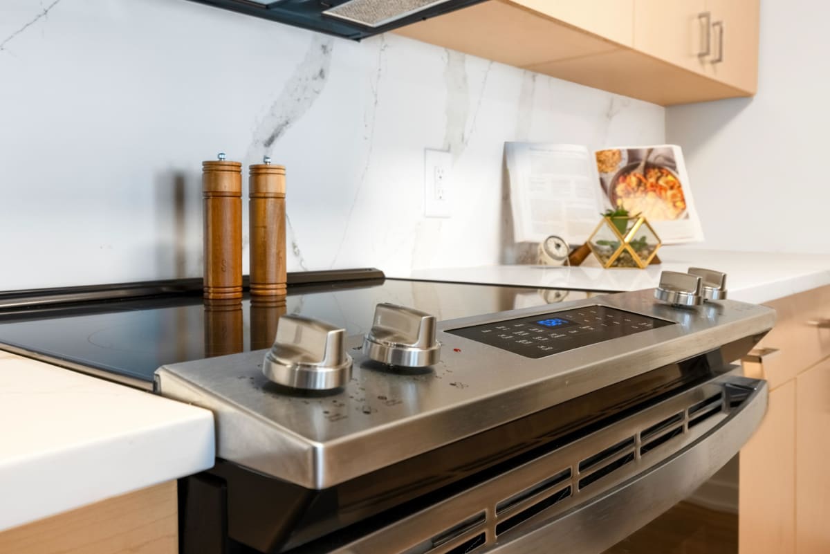 The Gramercy apartment kitchen with stove and sink - White Plains, NY