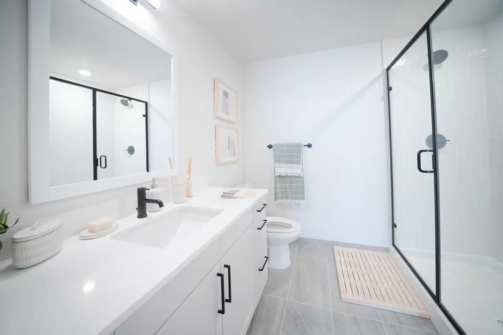 Harwood Flats apartment bathroom with vanity and shower - North Bethesda, MD