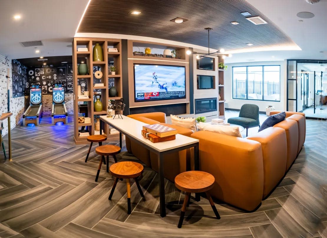Harwood Flats entertainment lounge with seating and TV - North Bethesda, MD