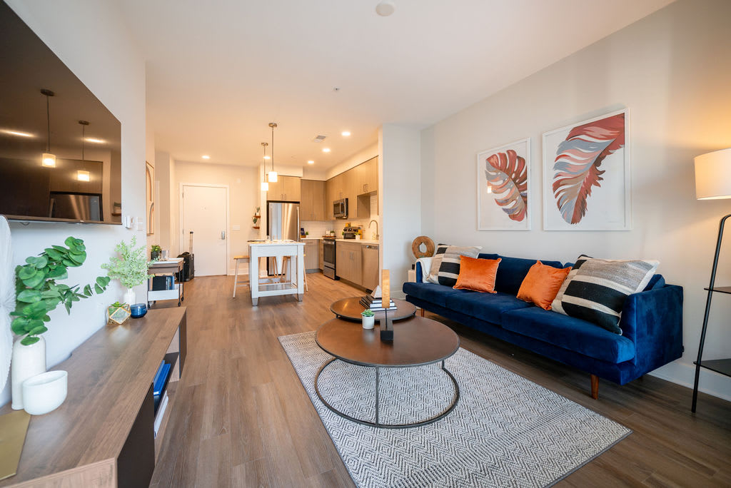 The Rae apartment living room with sofa and table - Bethesda, MD