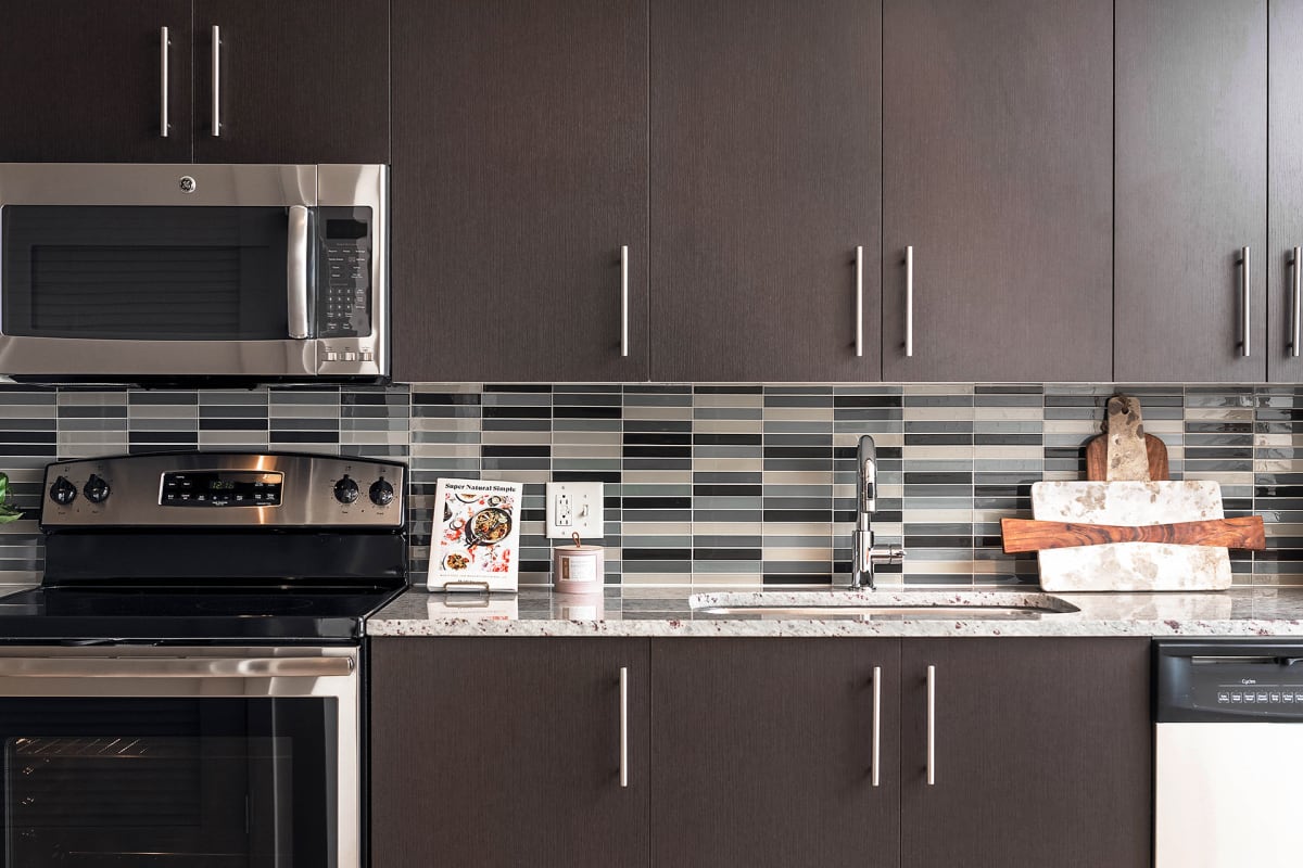 The Beacon Clarendon apartment kitchen with stainless steel appliances - Arlington, VA