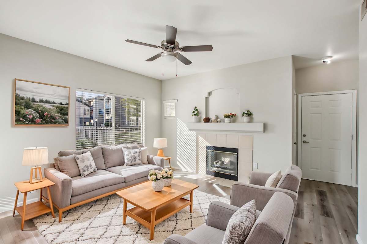 Furnished apartment living area shown — representative home at Sweetwater at Metro North.