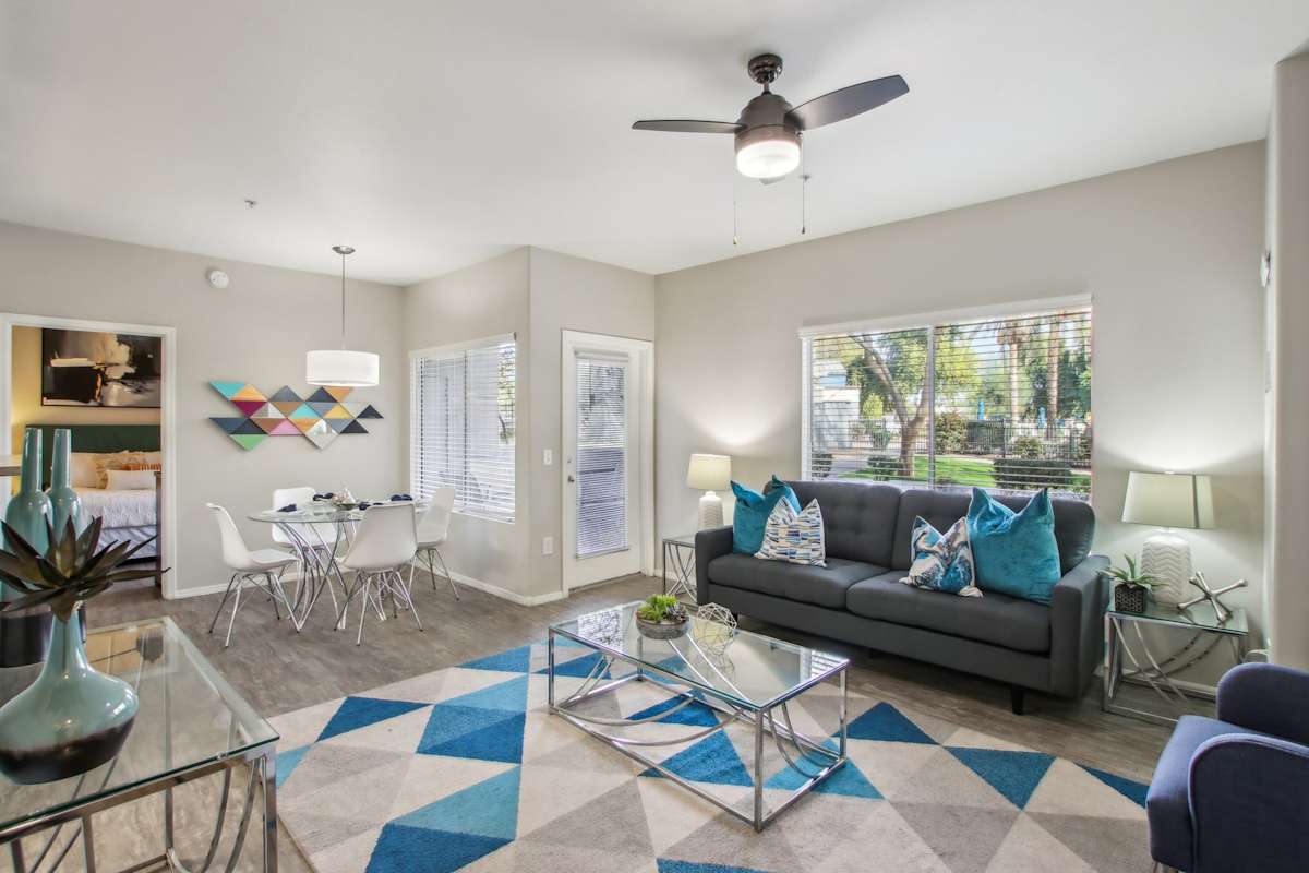 Furnished apartment living area shown — representative home at Sweetwater at Metro North.