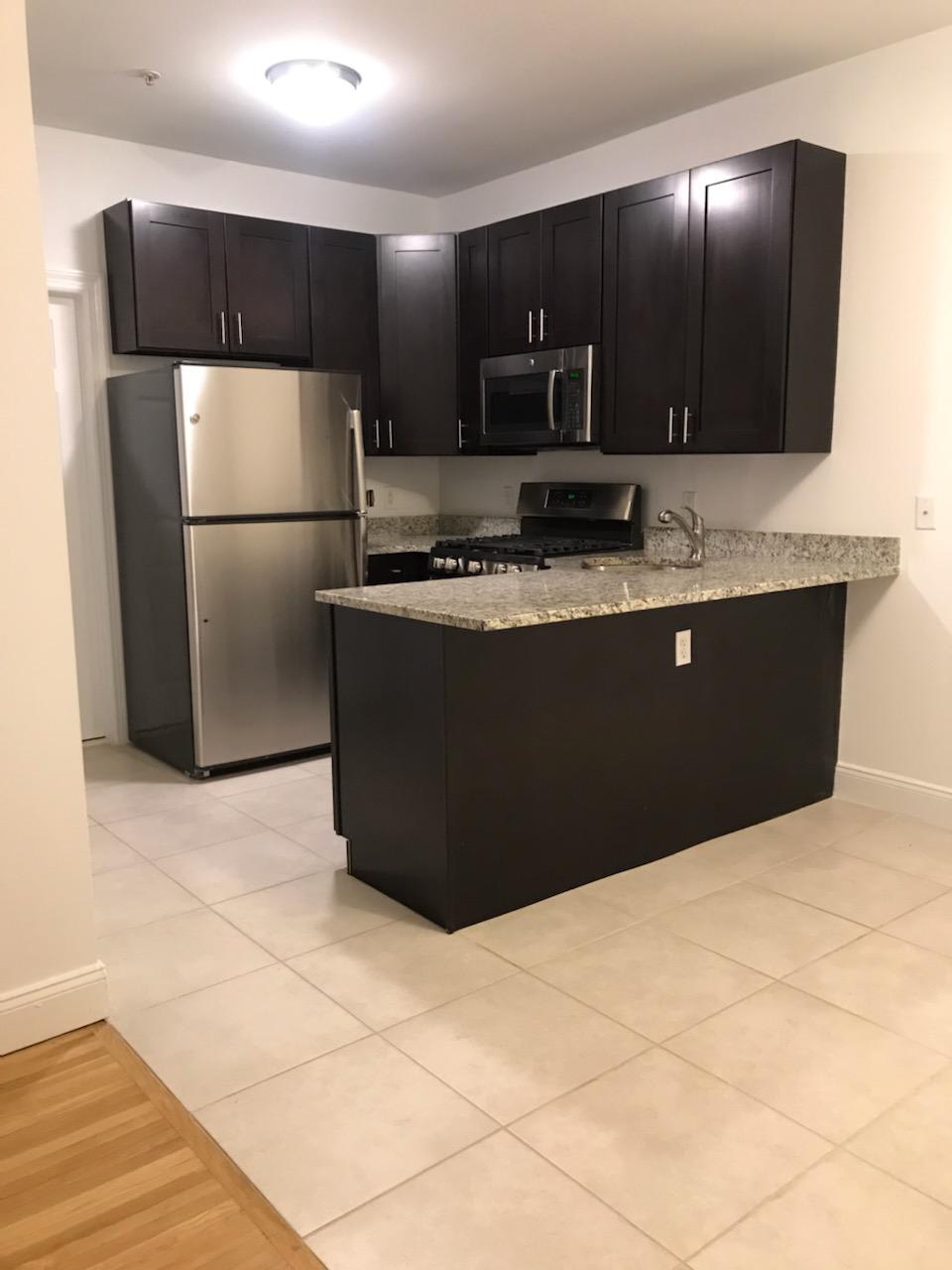Mariners Landing renovated kitchen with black cabinets - Edgewater, NJ