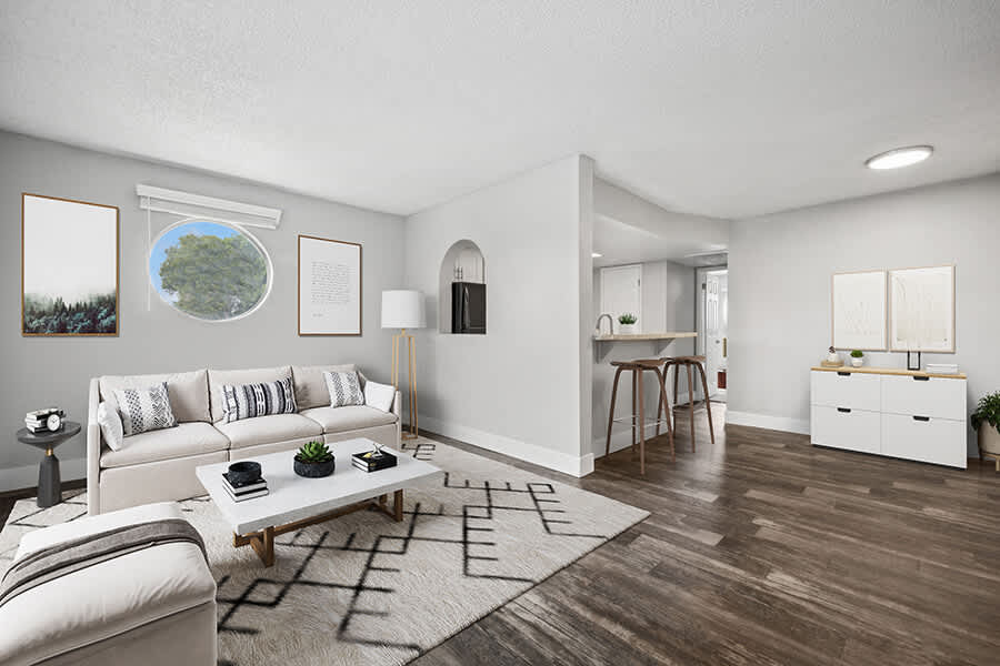 Furnished living room beside an open kitchen — view 1 at Stillwater Apartments.