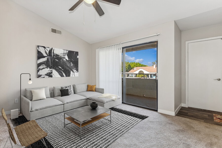 Furnished apartment living area shown — representative home at Lore South Mountain.
