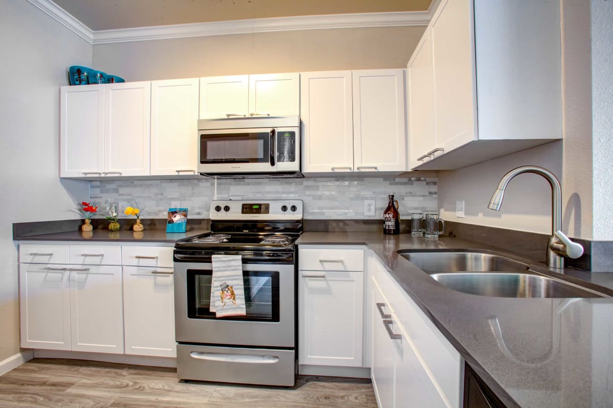 Apartment kitchen with stainless-steel appliances at Ironhorse at Tramonto.