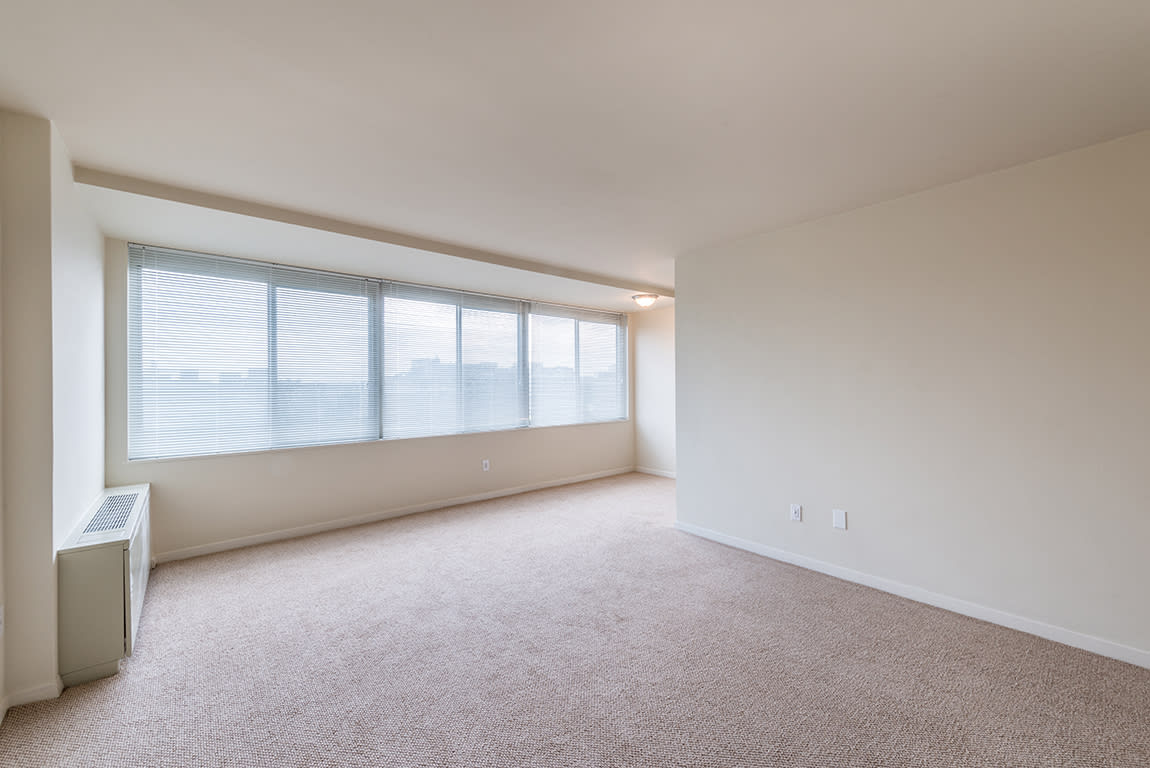 The 925 Apartments living area with expansive windows - Washington, DC
