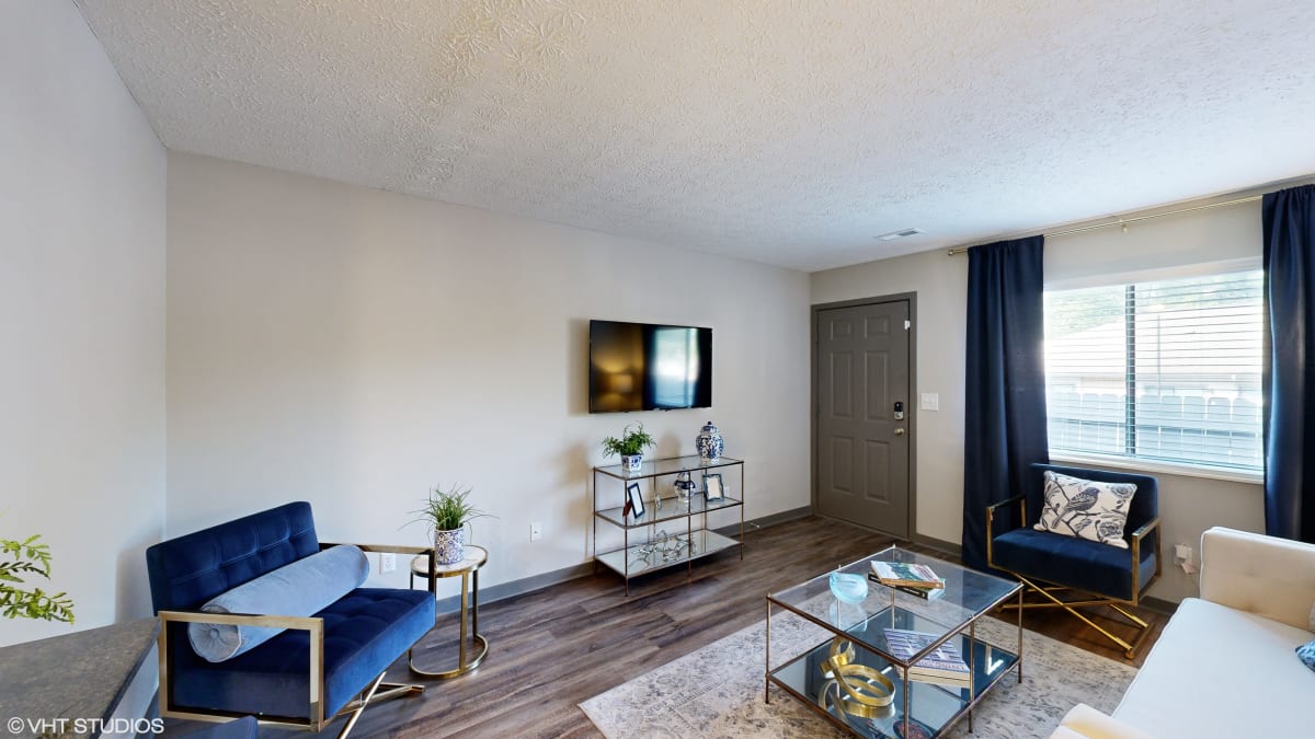Silvertree at Little Turtle Apartments living room with blue couches - Westerville, OH