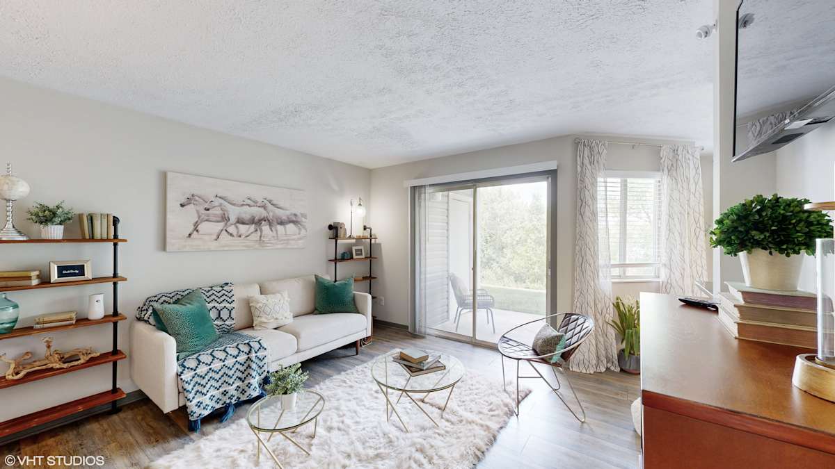 Runaway Bay Apartments living room with white sofa and patio door - Columbus, OH