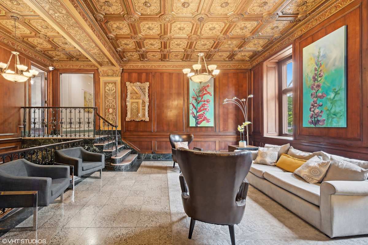 CWE Apartments lounge seating area with wood paneling - St. Louis, MO