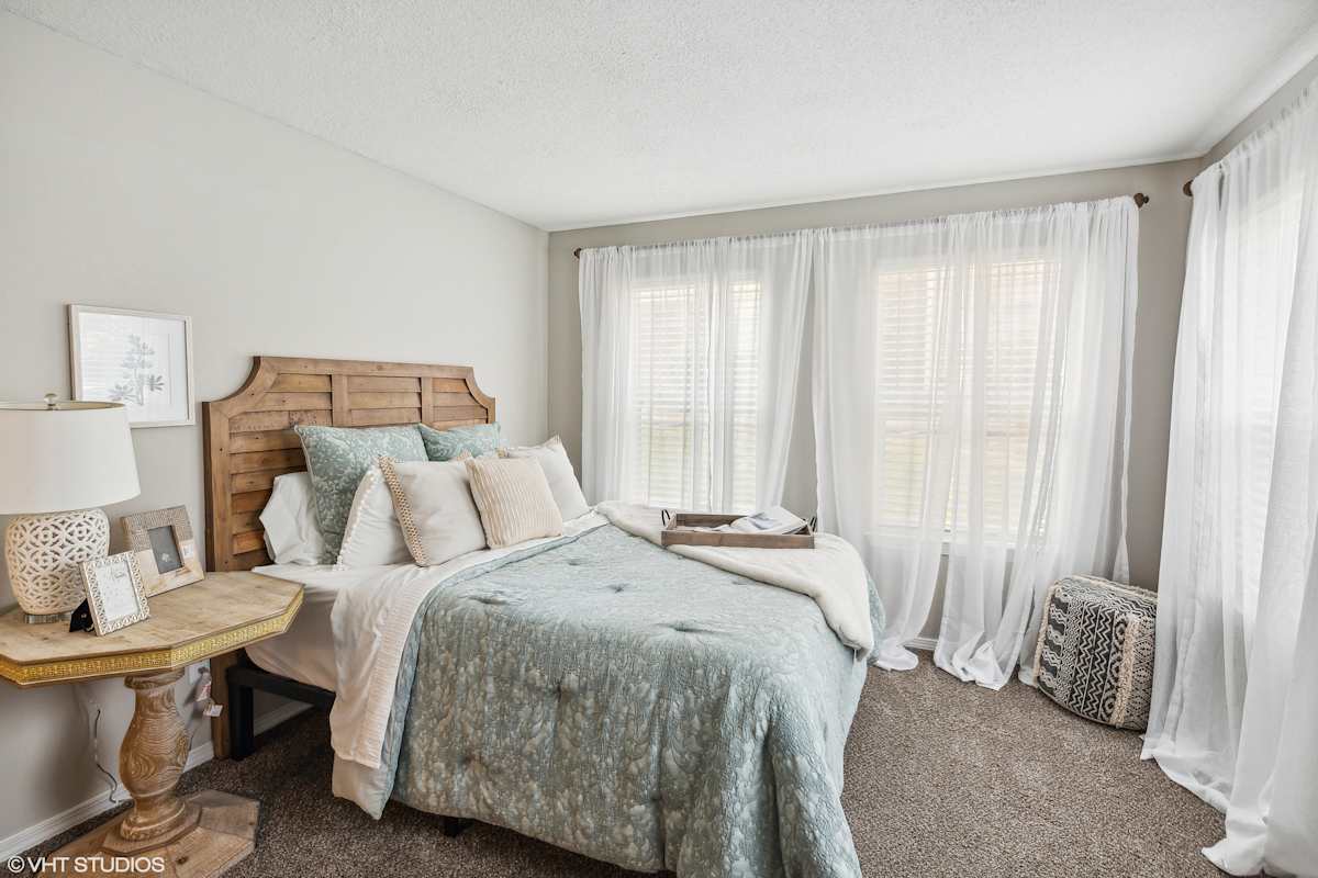 The Local Apartments bright bedroom with white curtains - Memphis, TN