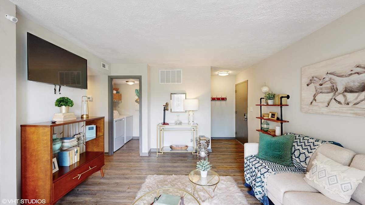 Runaway Bay Apartments living room with TV and seating - Columbus, OH