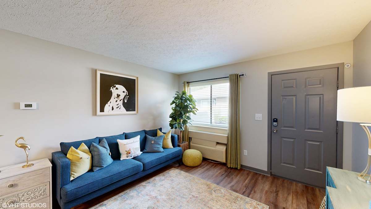 Springburne at Polaris Apartments living room with blue couch - Columbus, OH