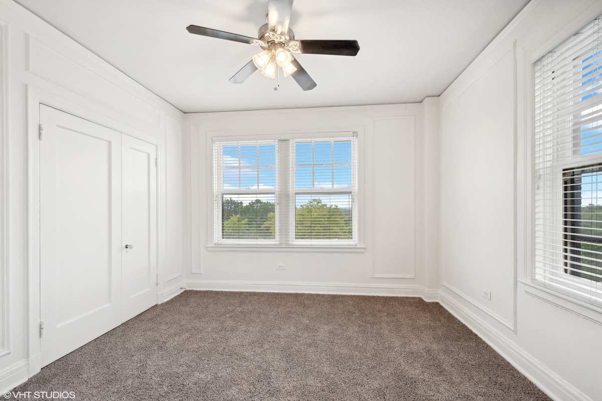 CWE Apartments bedroom with ceiling fan and windows - St. Louis, MO