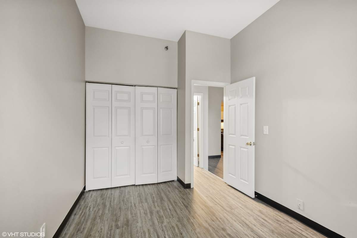 Delmar Loop Apartments living room with wood flooring - St. Louis, MO