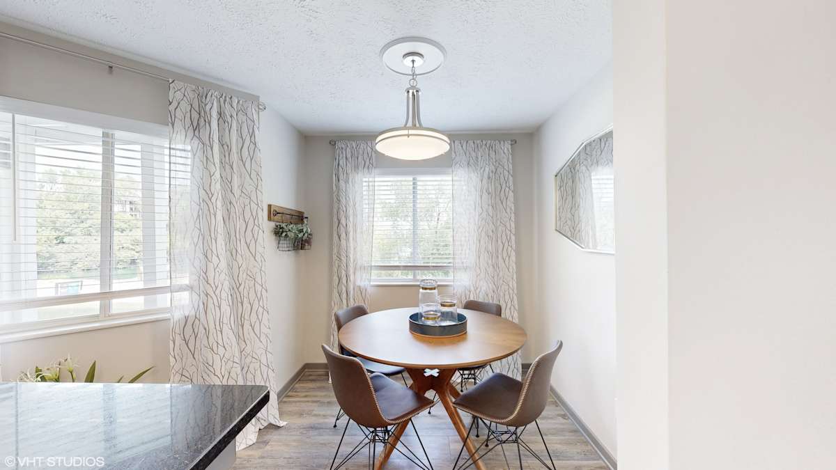 Runaway Bay Apartments dining area with table and chairs - Columbus, OH