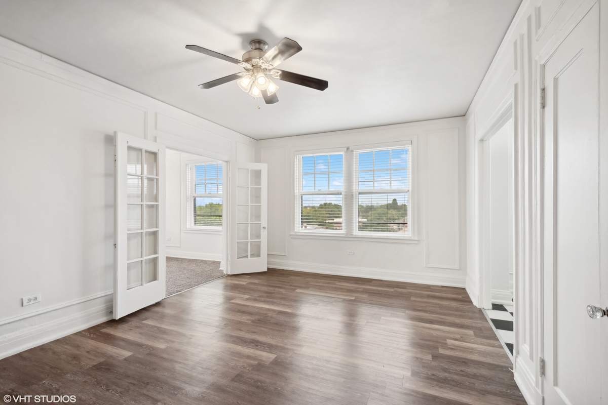 CWE Apartments empty living room with ceiling fan - St. Louis, MO