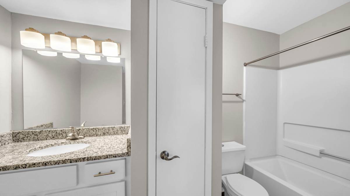 The Nova Apartments bathroom with vanity and mirror - Memphis, TN